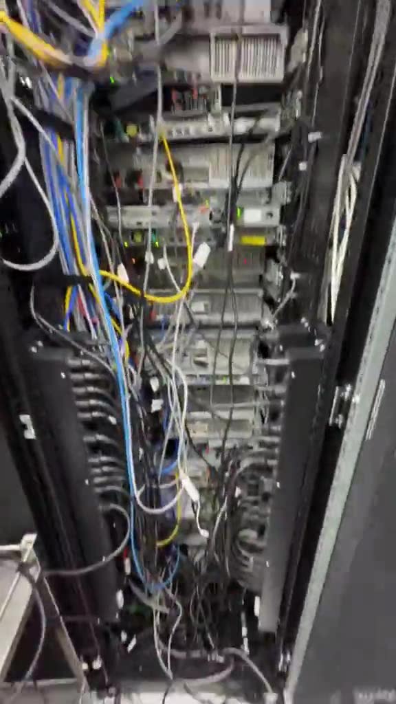 Rear cabling of an eWebGuru server rack showing power and network uplinks in a Tier IV datacentre